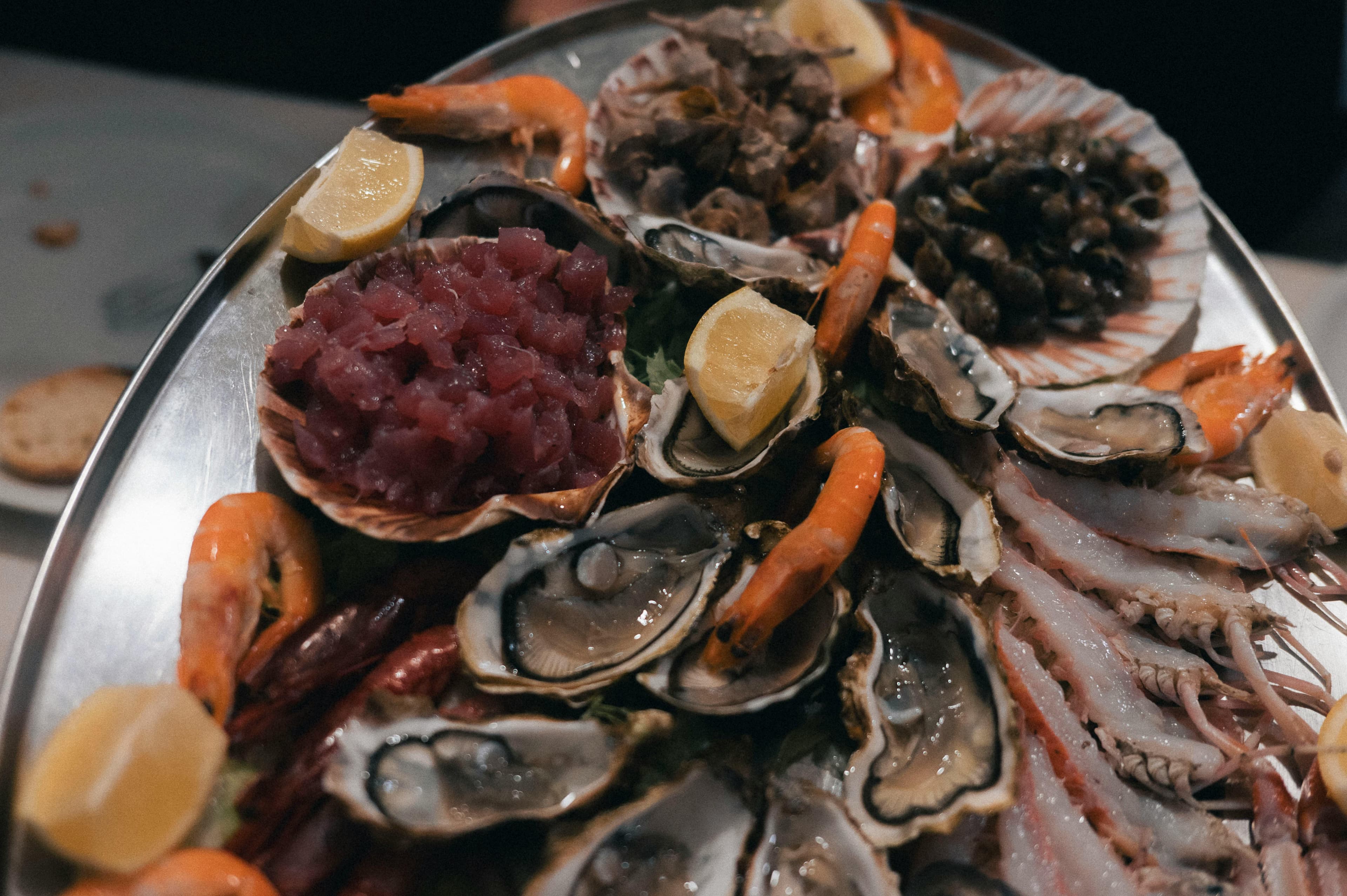 A platter of fresh oysters, shrimp, and tuna tartare
