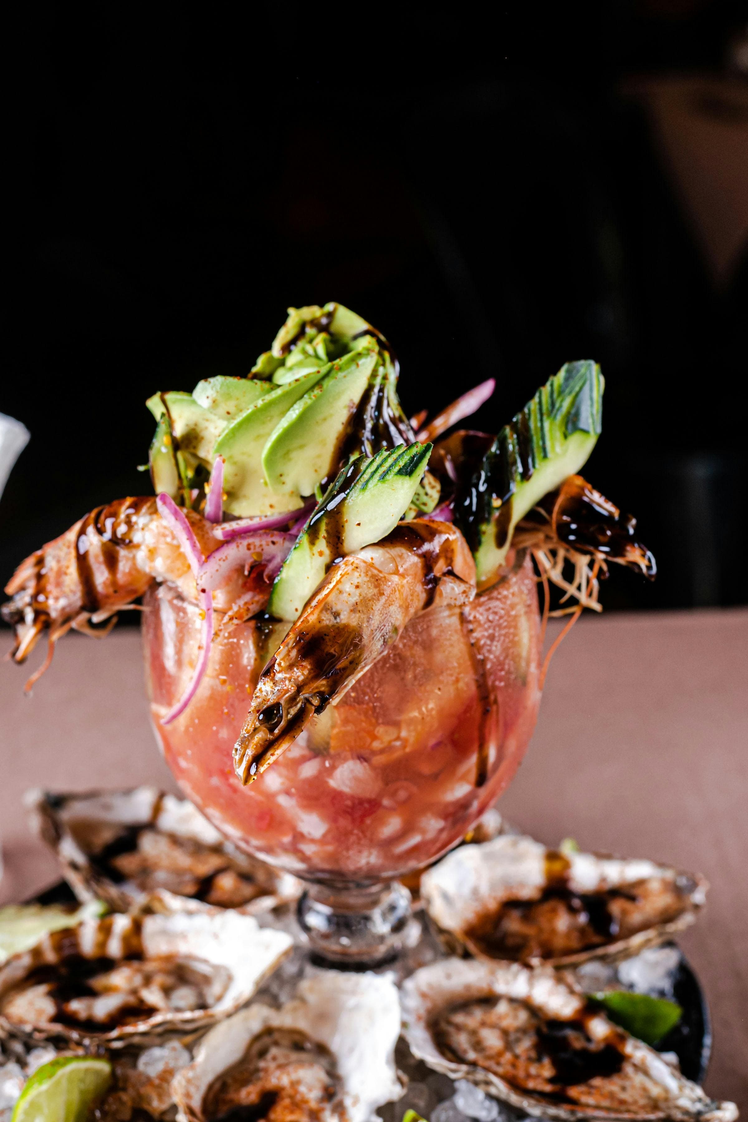 Shrimp cocktail with avocado over a bed of oysters